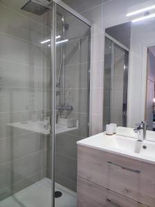 a bathroom with a glass shower and a sink at Studio Harmony - Zen et Confort - Hypercentre in Troyes