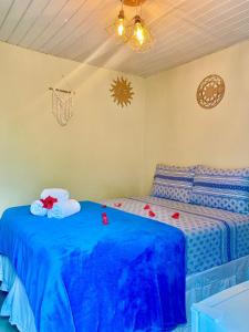 a bedroom with two twin beds with blue sheets at Pousada Misticasa Fernando de Noronha in Fernando de Noronha