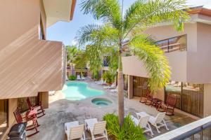 an aerial view of a resort with a pool and palm trees at The Cove at Playa Ocotal in Coco