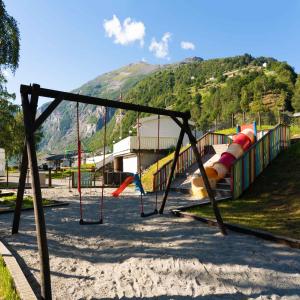 a park with a playground with a slide at Geirangerfjorden Feriesenter in Geiranger