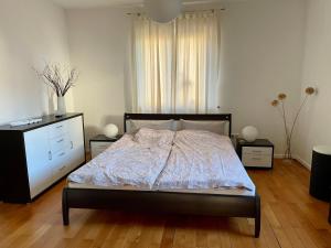 um quarto com uma cama, uma cómoda e uma janela em Ferienwohnung Bett & Burg em Wertheim