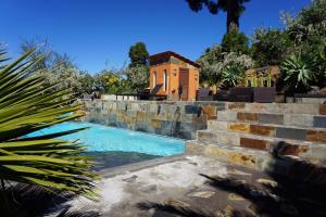 a swimming pool with stairs leading to a house at Panorama Suite El Mirador in Puntagorda