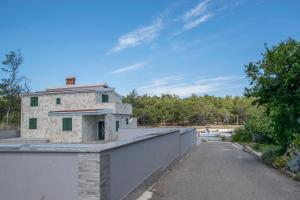 a building on the top of a wall with a road at Apartments Sana 2 in Vir