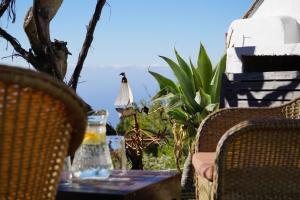 an outdoor table with two chairs and a table with a drink on it at Panorama Suite El Mirador in Puntagorda +42 photos