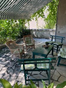 a patio with tables and chairs under a canopy at A big apartment for a big holiday! in Sumpetar