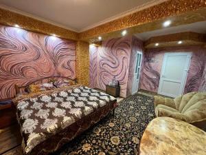 a bedroom with a bed and a colorful wall at Golden Rose in Chişinău