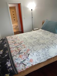 a bedroom with a bed with a floral comforter at Vancouver Downtown Central 1 bedroom Condo in Vancouver