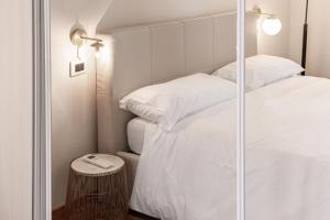 1 dormitorio con 2 camas y pared de cristal en Montello Livings, Exclusive terrace and skyline view, en Milán