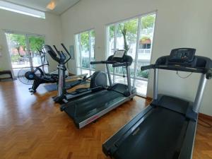 a gym with treadmills and exercise bikes in a room at Perfect Marina Stay@ Strait Quay /w Big Balcony + Carpark in Bagan Jermal