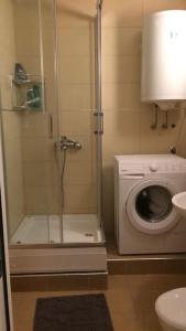 a bathroom with a shower with a toilet and a shower at Newly equipped Arena apartment in Belgrade