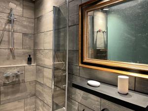 a bathroom with a shower with a glass door at Appartement Signature Art Déco in Valence