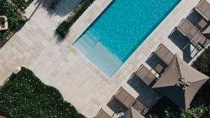 een uitzicht over een zwembad met een parasol bij PALAZZO FRANGIPANE in Salve