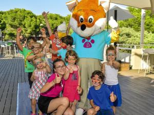 Un groupe d'enfants posant devant une mascotte dans l'établissement Belambra Clubs Presqu'île De Giens - les Criques, à Hyères