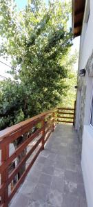 un balcón con una valla de madera y un árbol en Departamento La Tercera en San Clemente del Tuyú