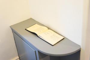 a book sitting on top of a blue desk at Newly-renovated, mid-terrace cottage in Porthmadog in Porthmadog