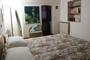 a bedroom with a large bed and a chair at Mari & Monti in Montignoso