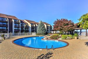 a swimming pool in front of a building at Waterfront Port Clinton Condo with Pool Access! in Port Clinton