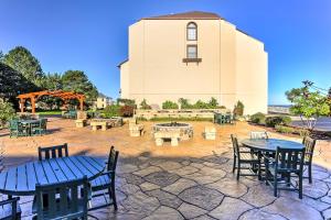 a patio with tables and chairs in front of a building at Waterfront Port Clinton Condo with Pool Access! in Port Clinton