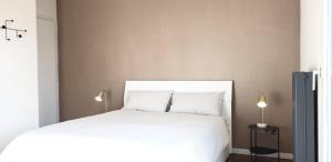 - une chambre avec un lit blanc et deux lampes dans l'établissement Venice & Treviso - ANTHEA design apartments, à Casièr