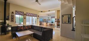 a living room with a couch and a table at Aviv Beautiful Villa, 5 BR, Golan Heights in Giv'at Yo'av