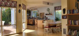 a kitchen with a table and chairs and a dining room at Aviv Beautiful Villa, 5 BR, Golan Heights in Giv'at Yo'av