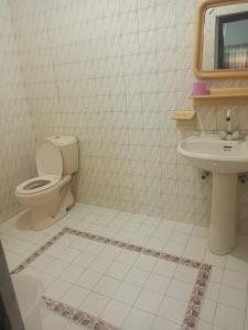 a bathroom with a toilet and a sink at Karachi Guest House & Couple Hotel in Karachi