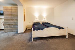 a bedroom with a large white bed in a room at Haus Dippel in Ruhpolding
