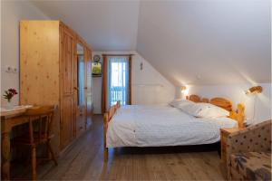 a bedroom with a bed and a desk and a table at Tourist Farm Klevž in Slovenj Gradec
