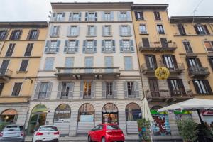 a large building with cars parked in front of it at View Luxury Duomo in Milan