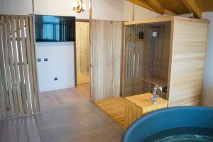 a large bathroom with a shower and a sink at Royal Alpin Crown in Cavnic