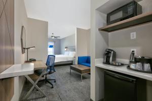 a hotel room with a bed and a desk and a room at Holiday Inn Express & Suites North Dallas at Preston, an IHG Hotel in Dallas