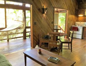 a living room with a table and a dining room at Tropical Treehouse in Sandy Bay