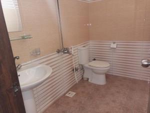 a bathroom with a toilet and a sink at Karachi Guest House & Couple Hotel in Karachi