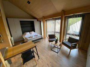 a room with a bed and a table and chairs at VIVERO 5 SMA in San Martín de los Andes