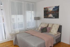 a bedroom with a bed and a painting on the wall at Ferienwohnung in Freilassing