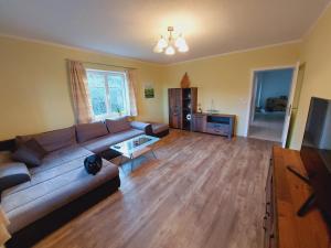 a living room with a couch and a table at Ferienwohnung Lucy am Lonitzberg in Steinakirchen am Forst