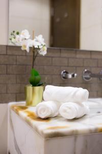 a pile of towels on a counter in a bathroom at Boutique Living - Park Island in Dubai