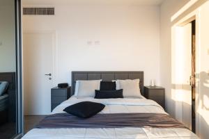a bedroom with a bed with two pillows on it at Master Bedroom with Private Bathroom in Luxury Shared Apt in Bat Yam