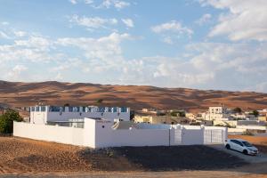 a white building in the middle of the desert at Bait Al Budoor rest house in Al Raka