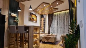 a wine tasting room with a bar and a couch at Palace 15 in Zlatibor