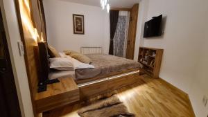 a bedroom with a bed with a mirror on it at Palace 15 in Zlatibor