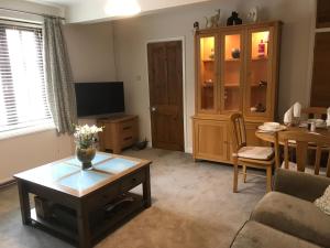 a living room with a couch and a table at Wrens Nest in Axminster