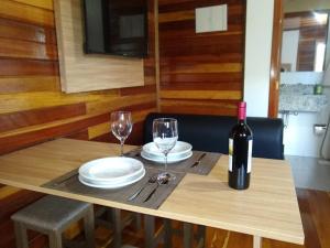 een tafel met twee glazen en een fles wijn bij Sítio Passo do Carro in São Francisco de Paula