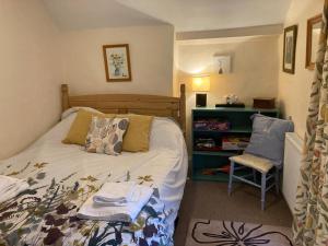 a bedroom with a bed and a chair in it at Bodwyn house in Dolgellau