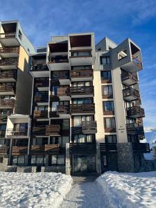 ein hohes Gebäude mit Schnee davor in der Unterkunft Grand 2 pièces traversant au Val Claret, 4 à 6 pers in Tignes