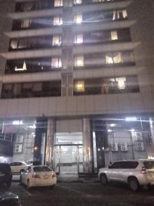 a parking lot in front of a building at night at dormitory bed space for male and female in Sharjah