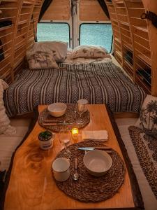 a table in the back of a rv with plates and glasses at Dreamer in Munster
