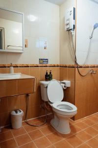 a bathroom with a toilet and a sink and a shower at JJ Palace เจเจ พาเลซ in Ban Si Than