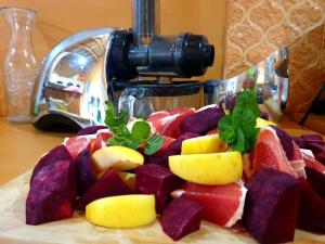 a plate of fruit on a table with a camera at Maison d'hôtes IZZA in El Kelaa des Mgouna +82 photos
