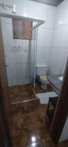 a bathroom with a shower and a toilet at Hospeda Maresias quartos in Maresias